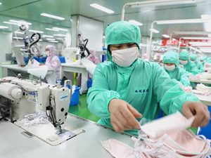 Workers make masks at a medical technology company in Binzhou High-tech Industry Development Zone in Binzhou City, east China's Shandong Province, Feb. 8, 2020. (Photo by Chu Baorui/Xinhua)